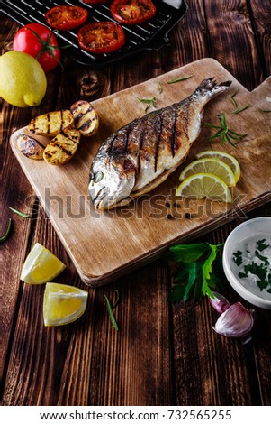 grilled fish with tomato and lemon