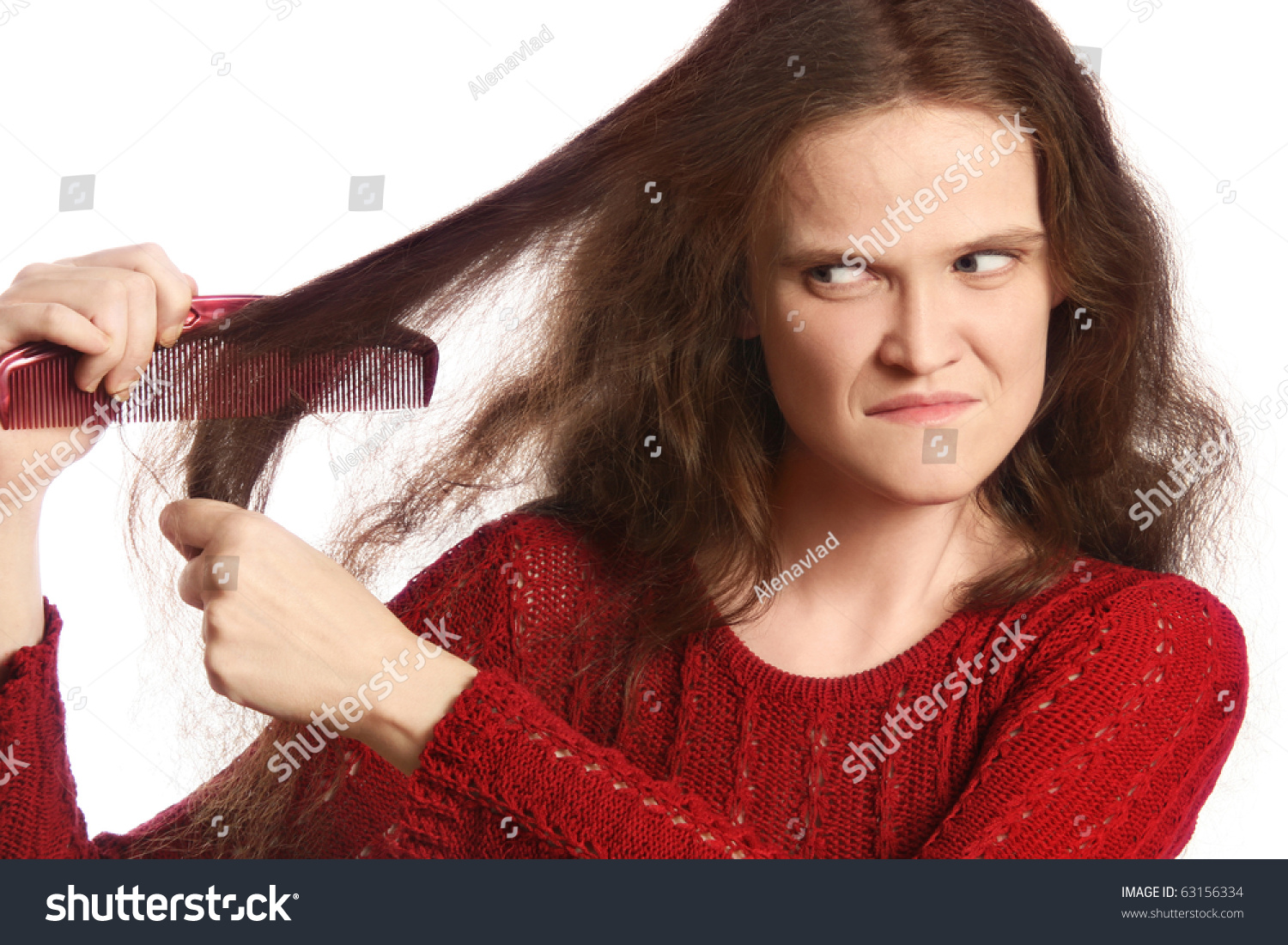 woman combing her long unmanageable unruly problematic hair